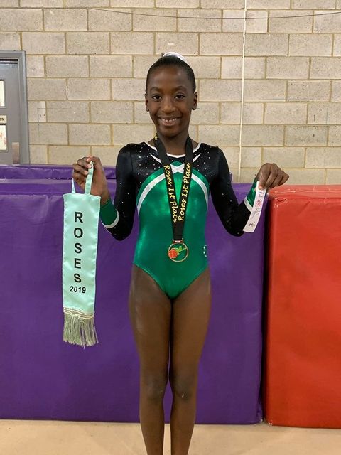 Gymnast with medal smiling after their competition