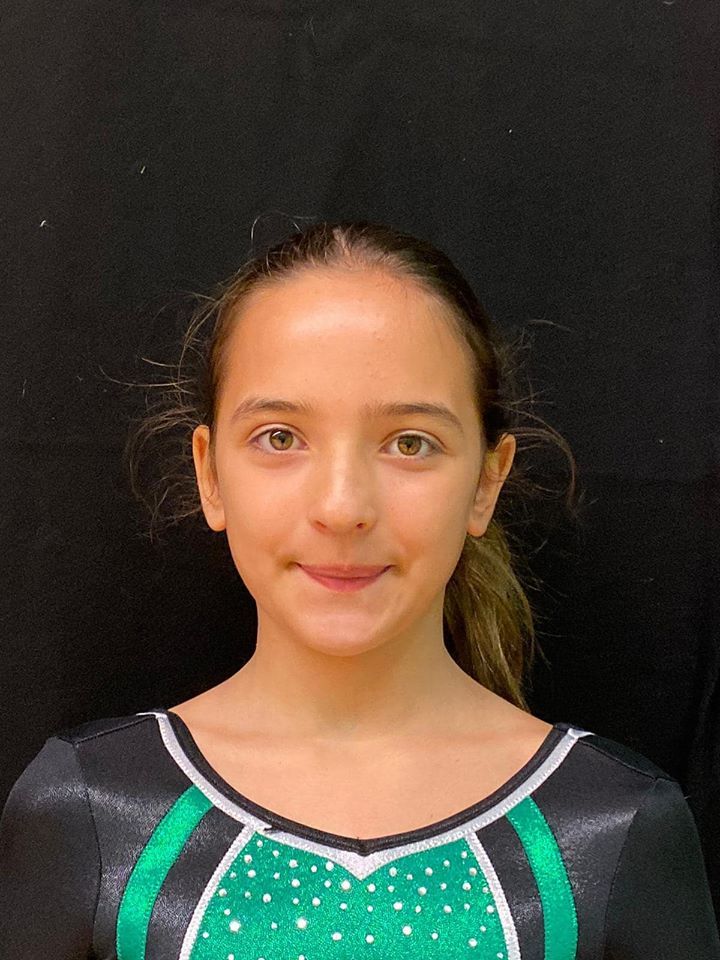 Gymnast smiling and celebrating after a competition