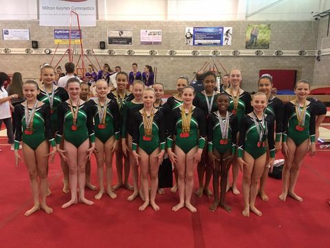 The gymnasts from the Tudor Rose round at the National Roses competition wearing the medals that they have won