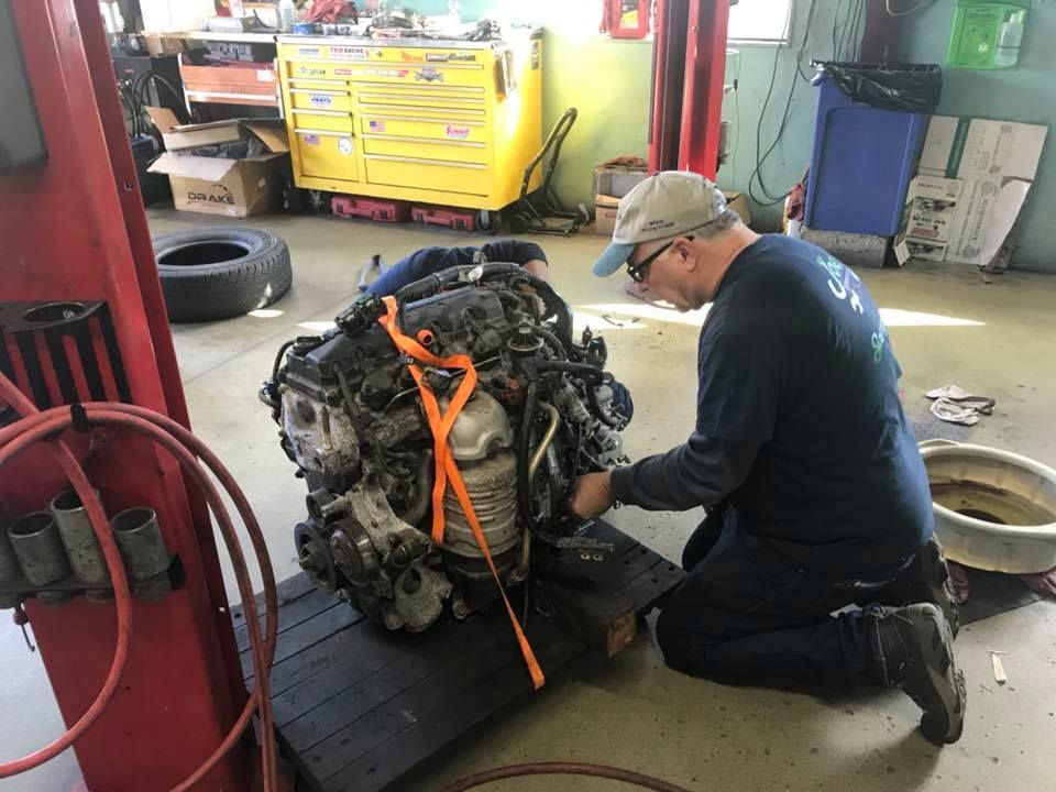 Technician Working on a Large Car Engine | Joe’s Garage Inc.