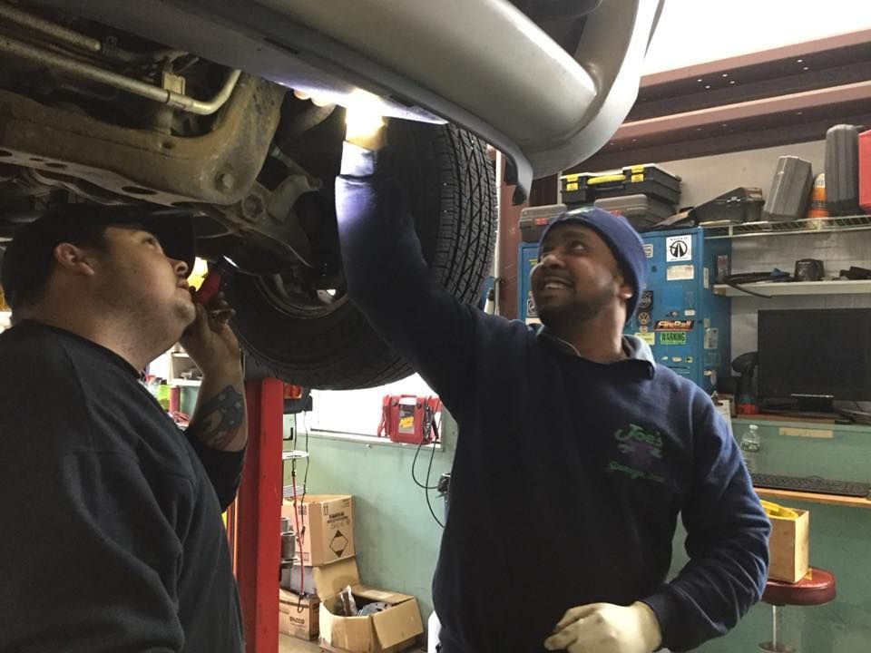 Mechanics Working on a Car | Joe’s Garage Inc.
