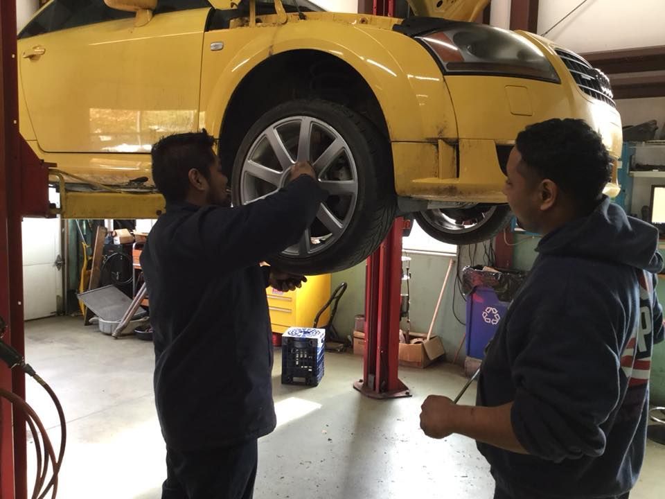 Mechanics Working on a Yellow Audi TT | Joe’s Garage Inc.