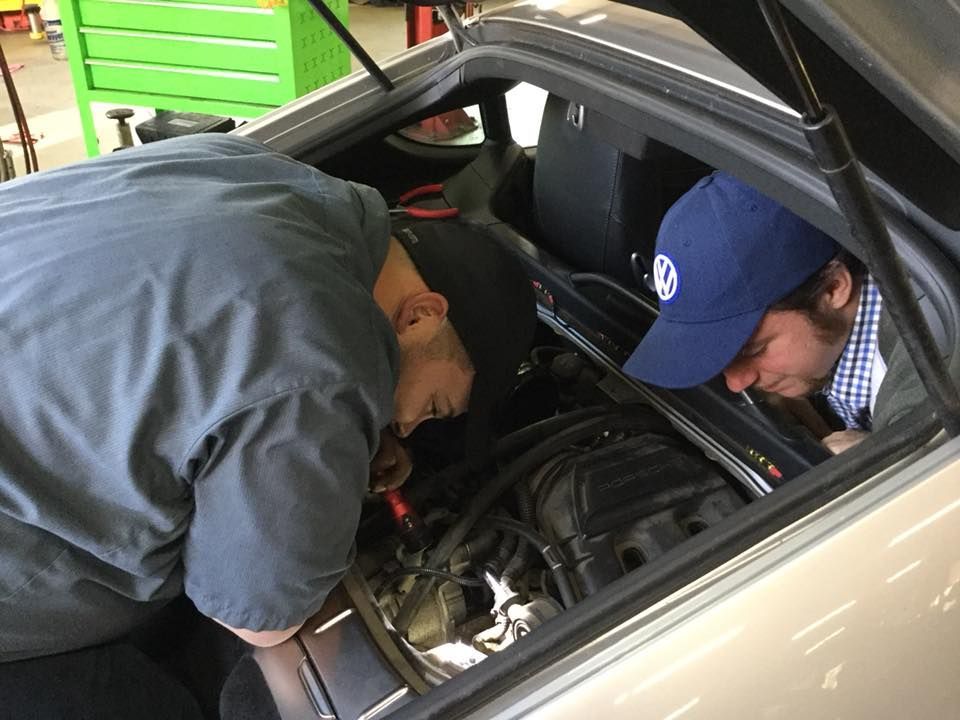 Mechanics Working on a Vehicle's Engine | Joe’s Garage Inc.
