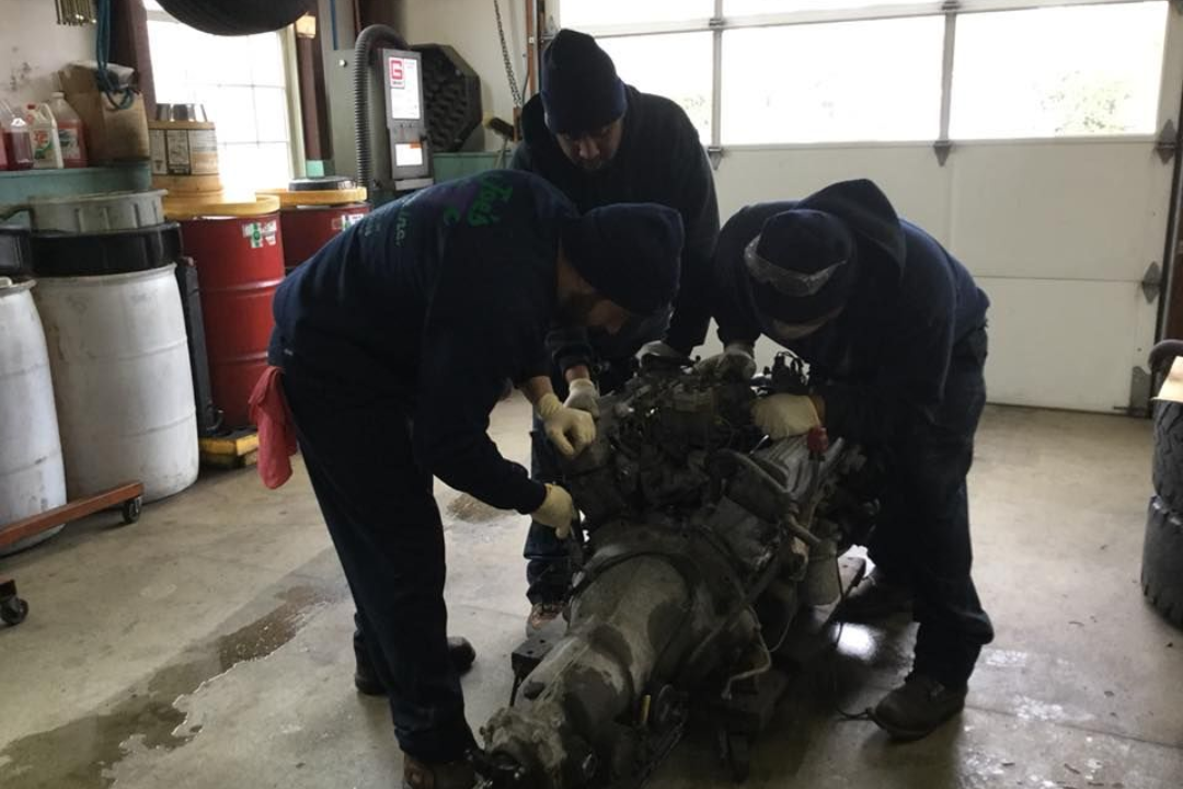 Mechanics Working on a Vehicle Engine | Joe’s Garage Inc.