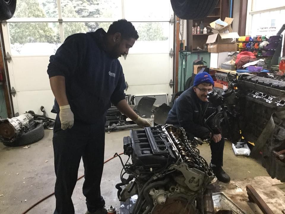 Mechanics Working on an Automotive Engine | Joe’s Garage Inc.