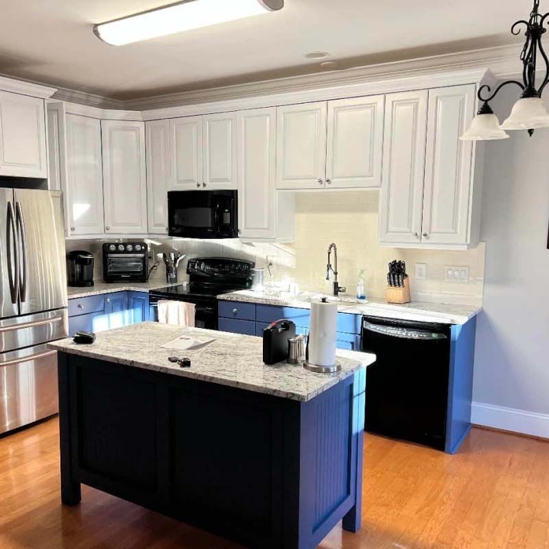 A kitchen with a large blue island in the middle