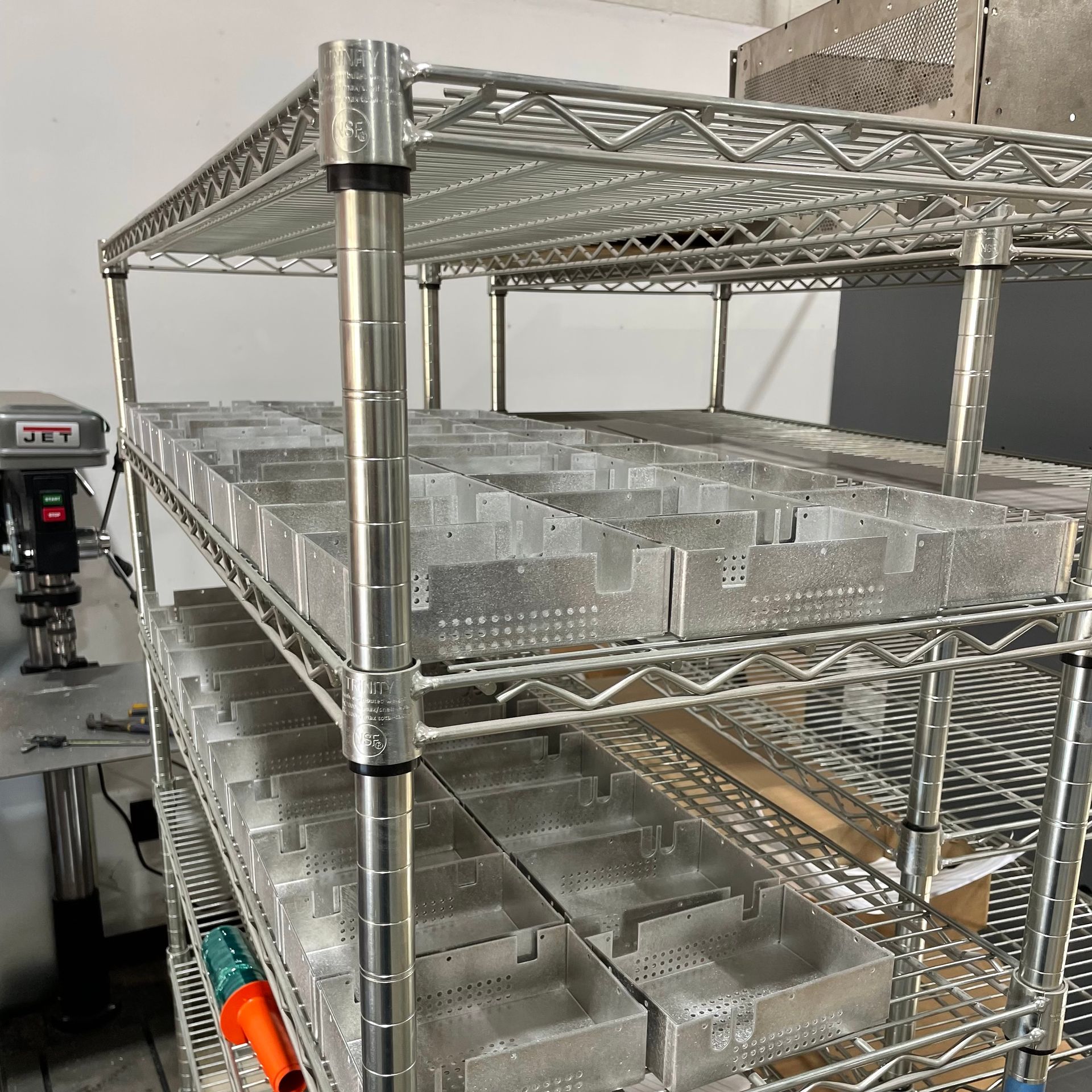 A metal shelf with lots of empty containers on it