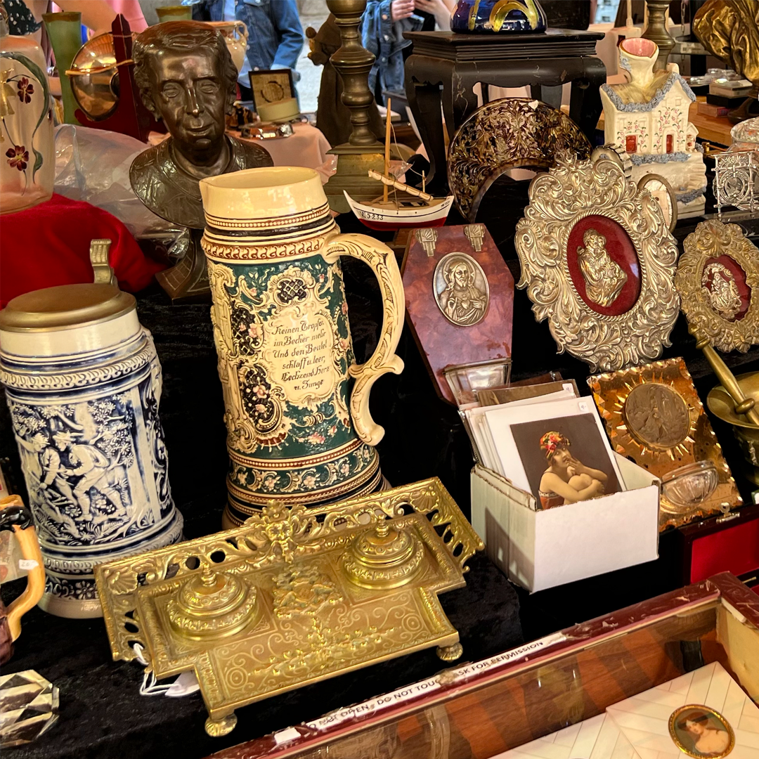 A table with a lot of antique items on it