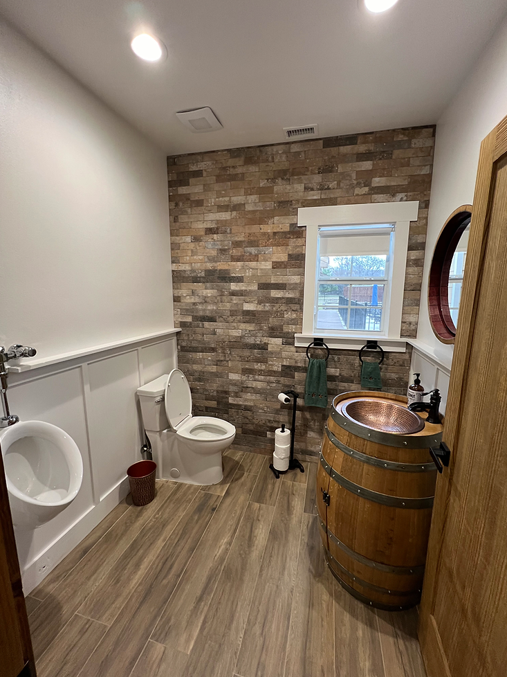 A bathroom with a toilet , sink and urinal.