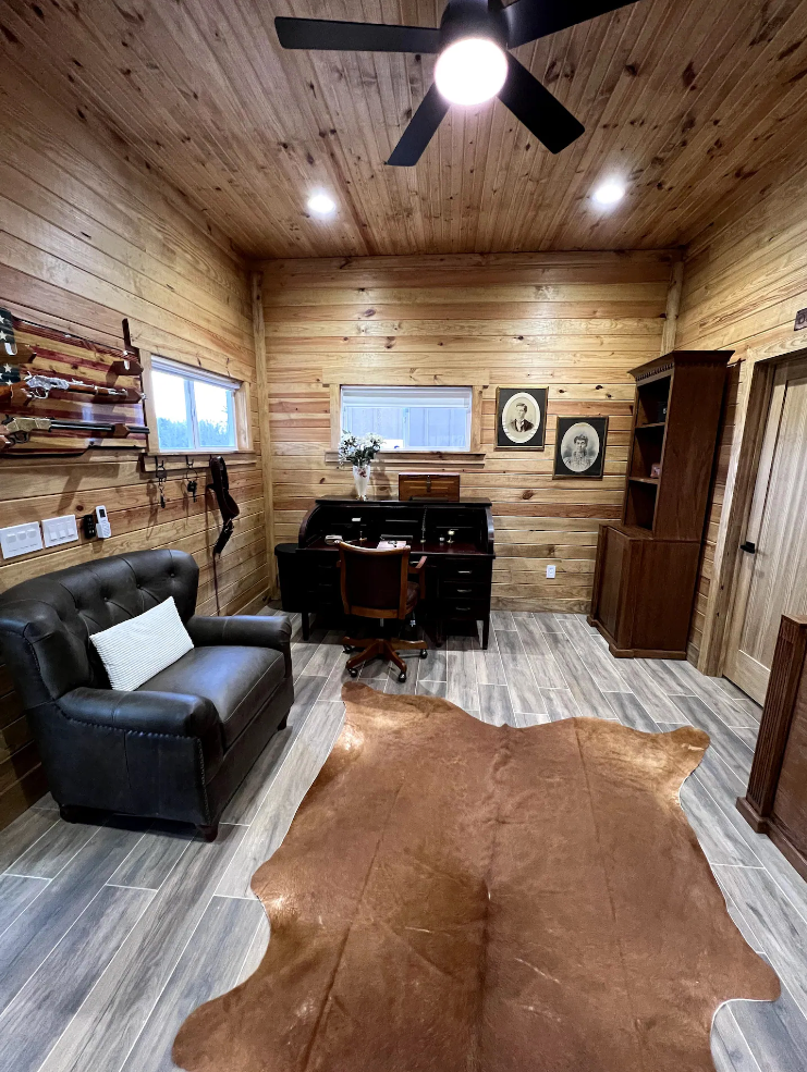 There is a cowhide rug in the middle of the room.