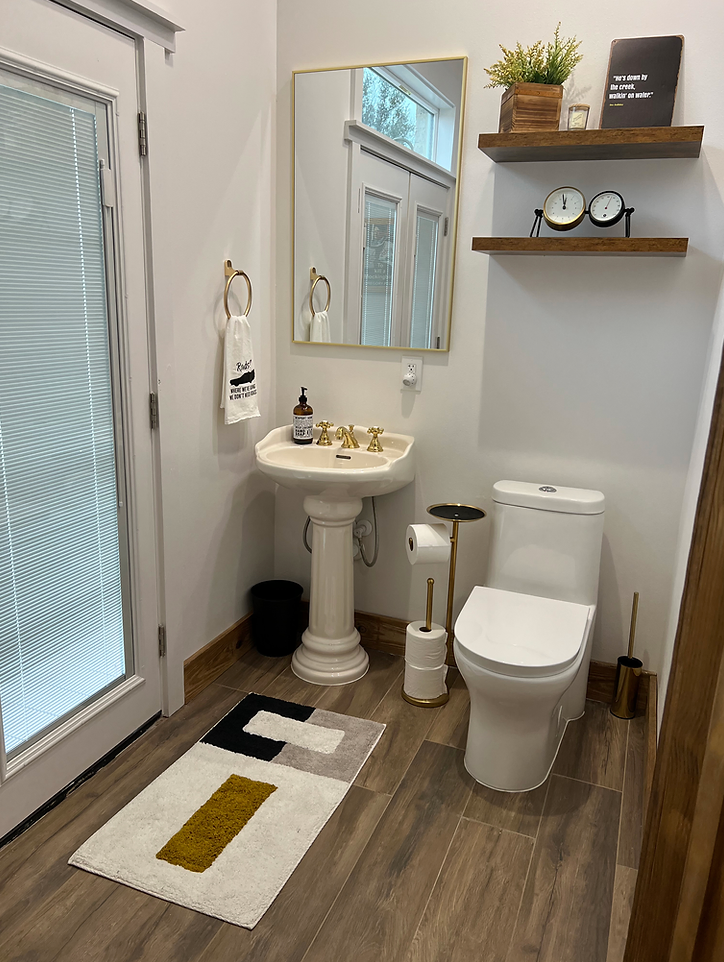 A bathroom with a sink , toilet , and mirror.