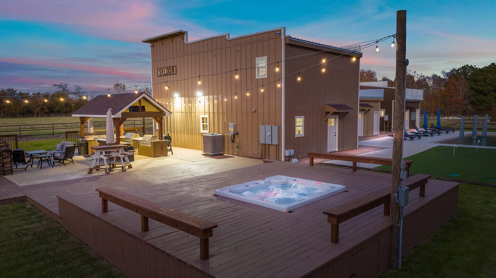 There is a hot tub on the deck of a house.