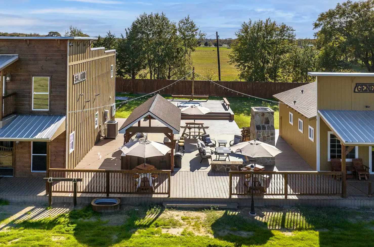 An aerial view of a house with a large deck and umbrellas.