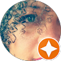 A close up of a woman 's face with curly hair in a circle.
