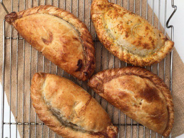 Four pastries are sitting on a cooling rack.