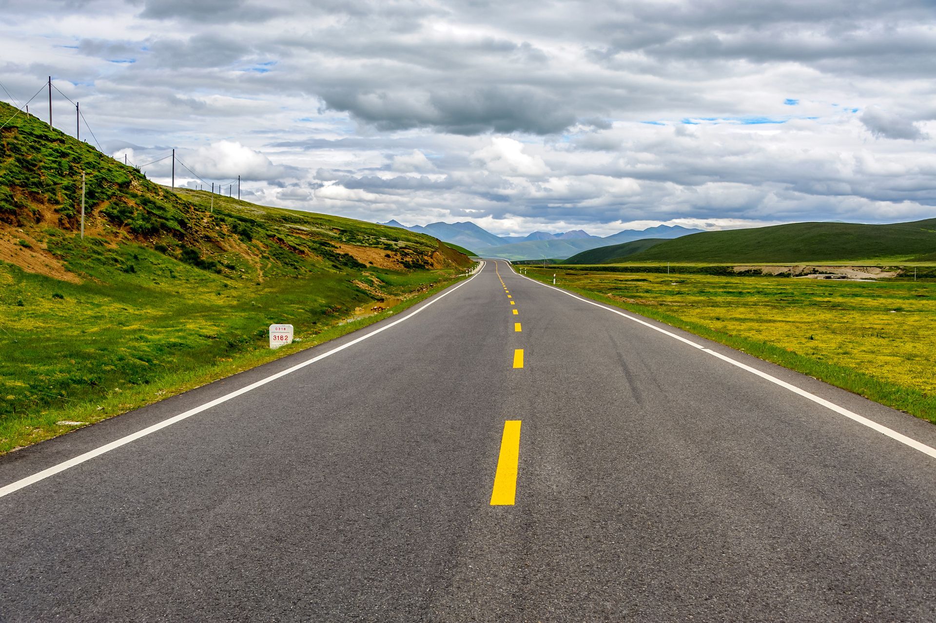 A road with a yellow line on the middle of it