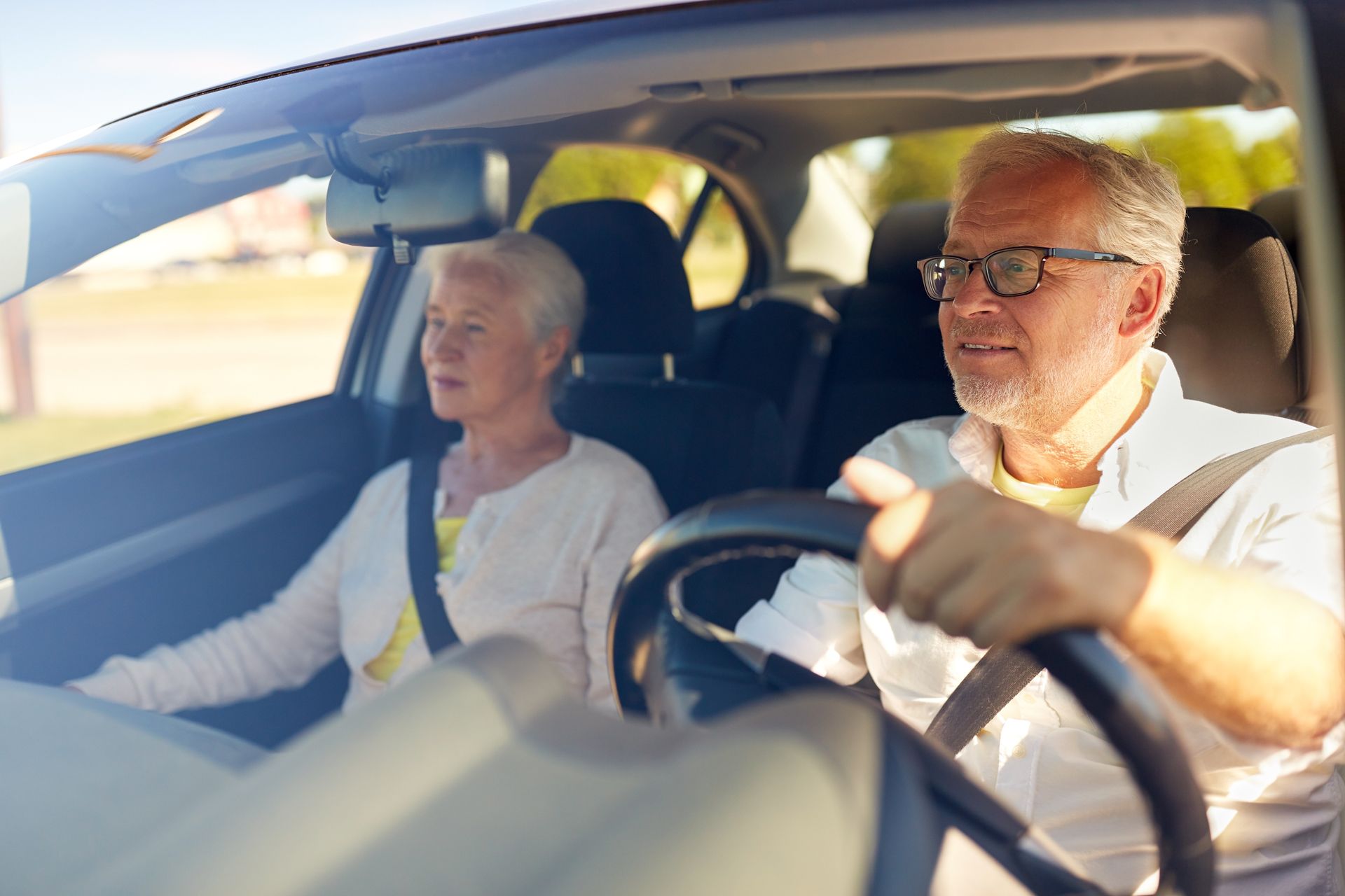 A man and a woman are sitting in a car