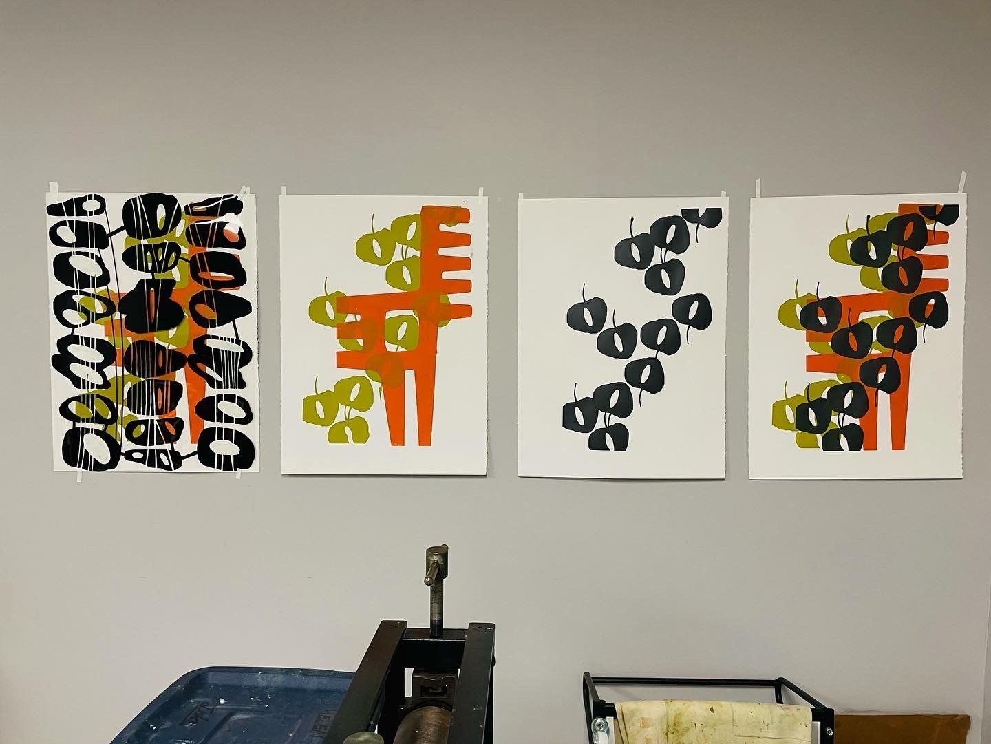 Four posters hanging on a wall with one that says ' a ' on it