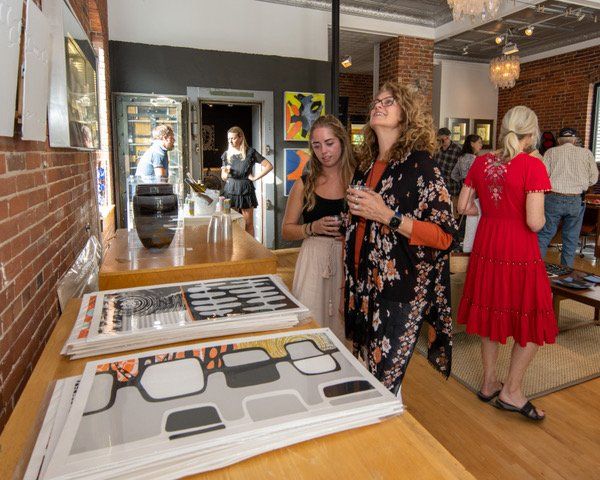 A woman in a red dress stands next to a woman in a black kimono