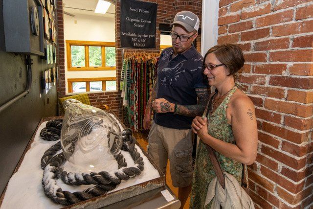 A man and a woman are looking at a display of ropes