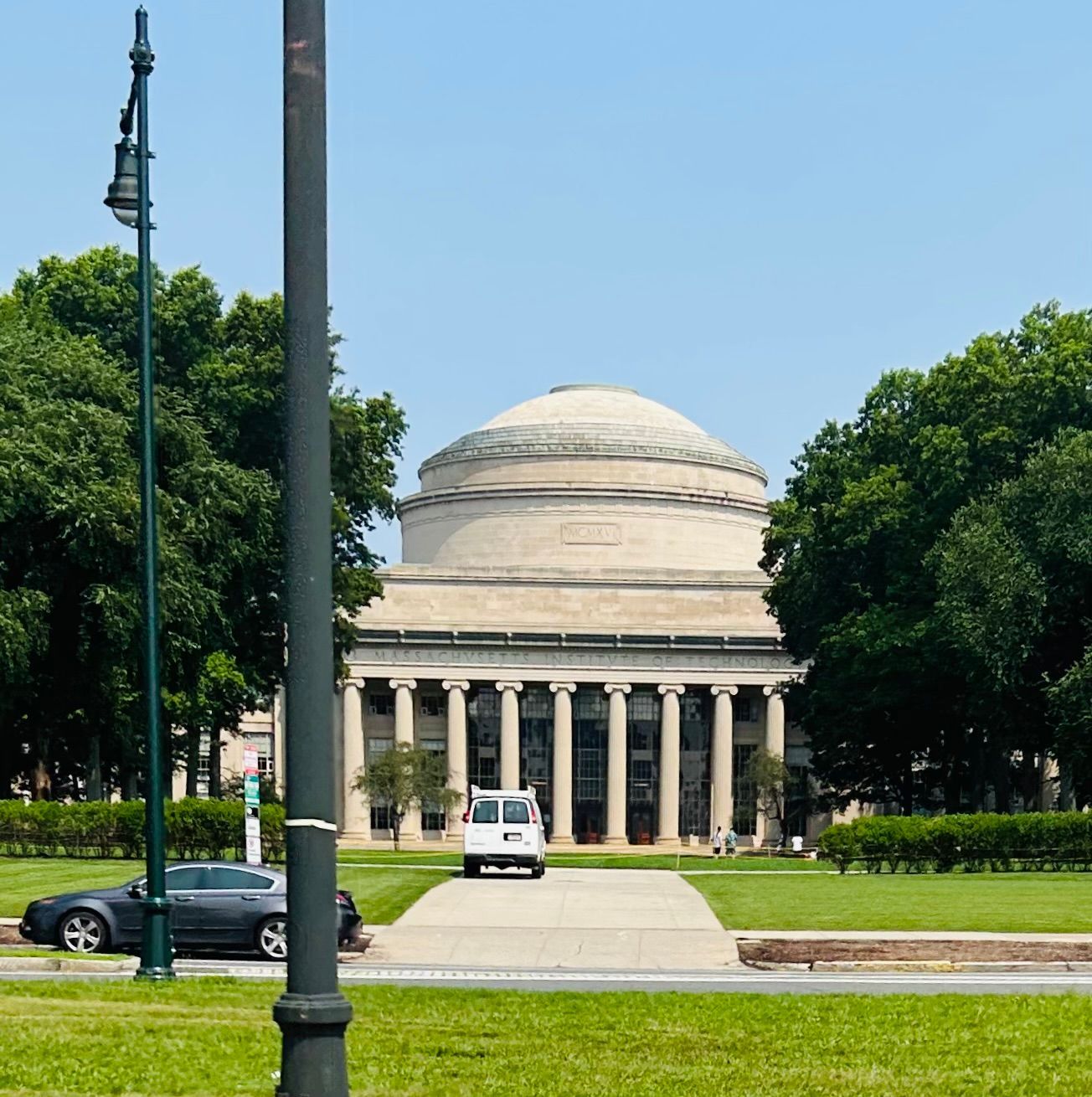 A car is parked in front of a large building