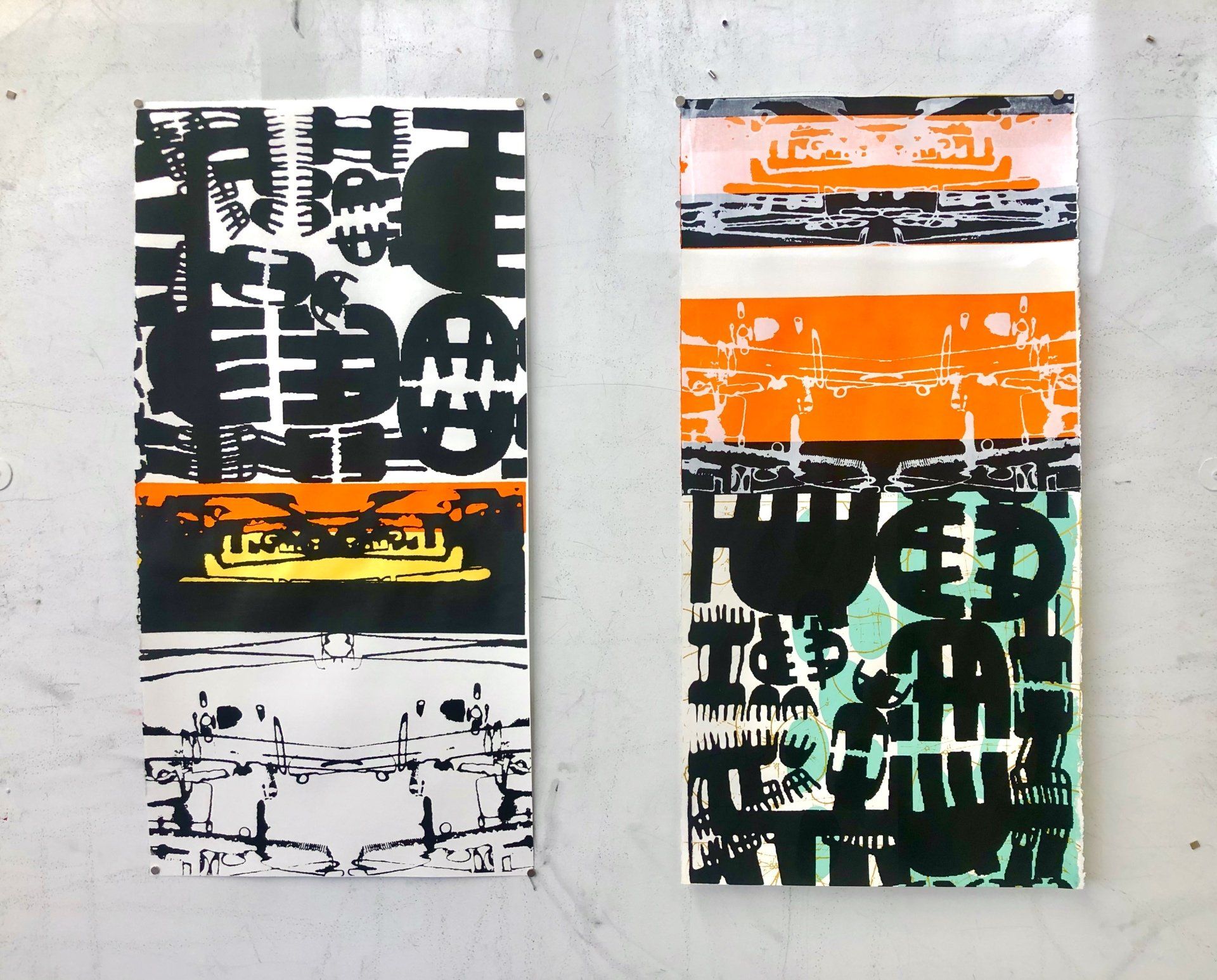 Two paintings are hanging on a wall one of which has a skull on it