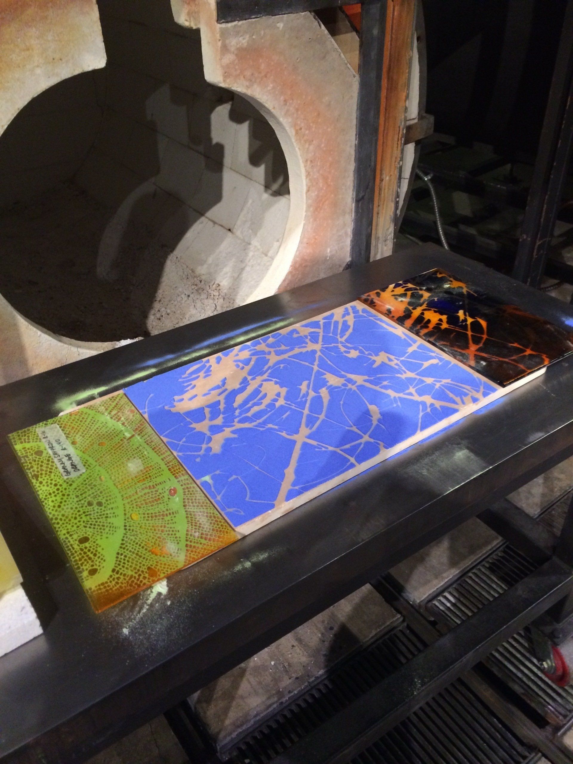 A table with a few pieces of art on it