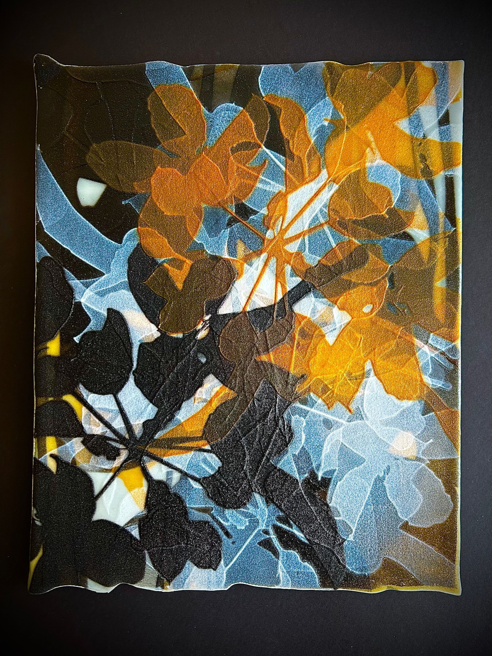 A painting of yellow and black leaves on a white background