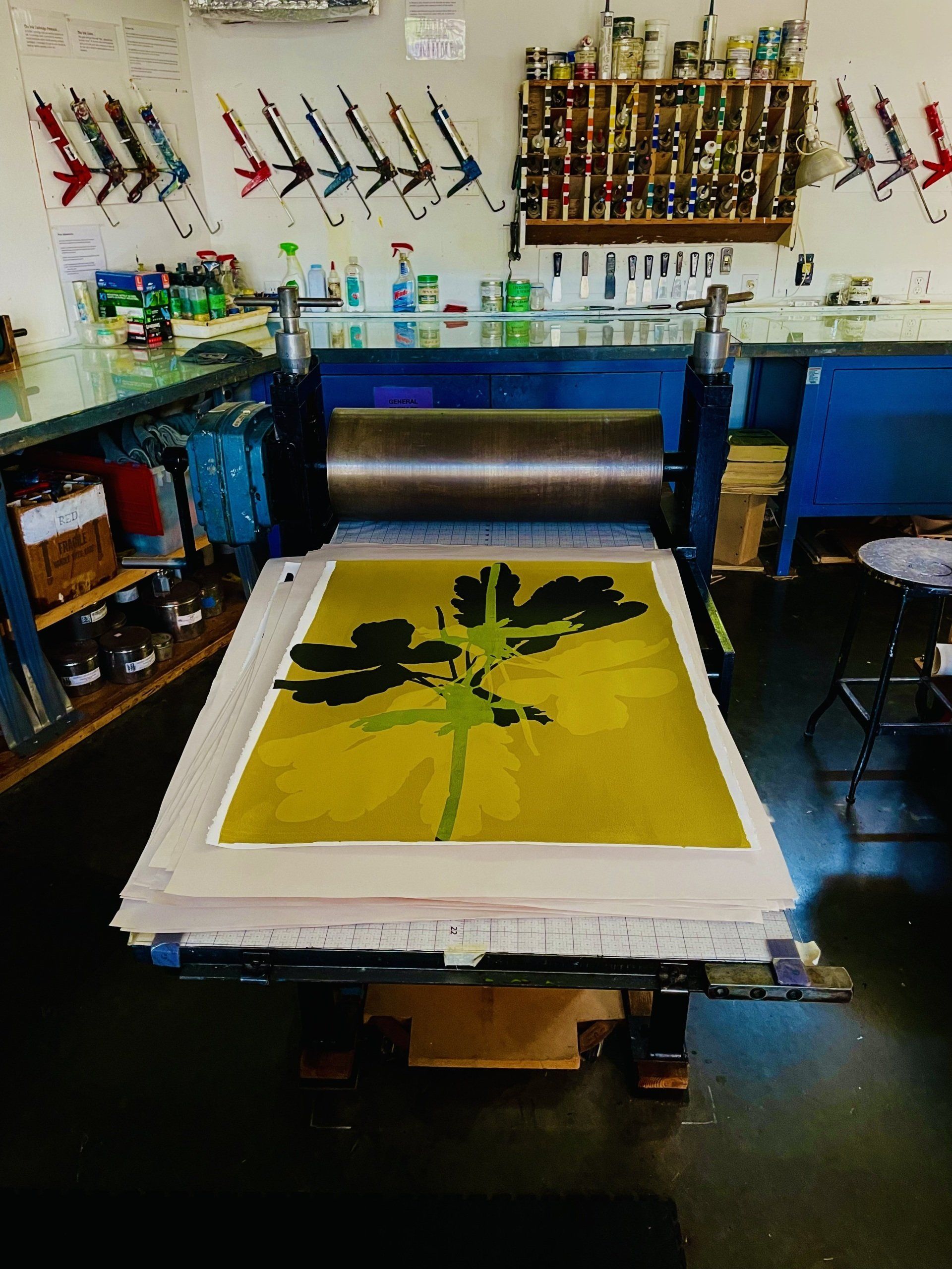 A painting of a tree is being printed on a machine