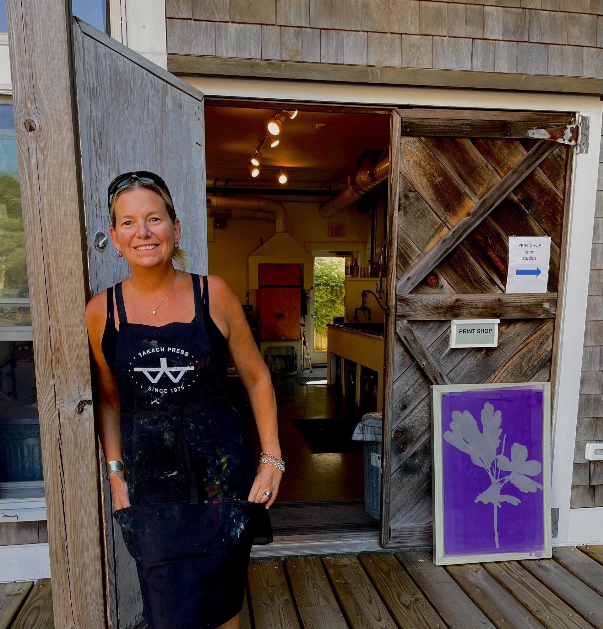 A woman in a black tank top with the letter a on it