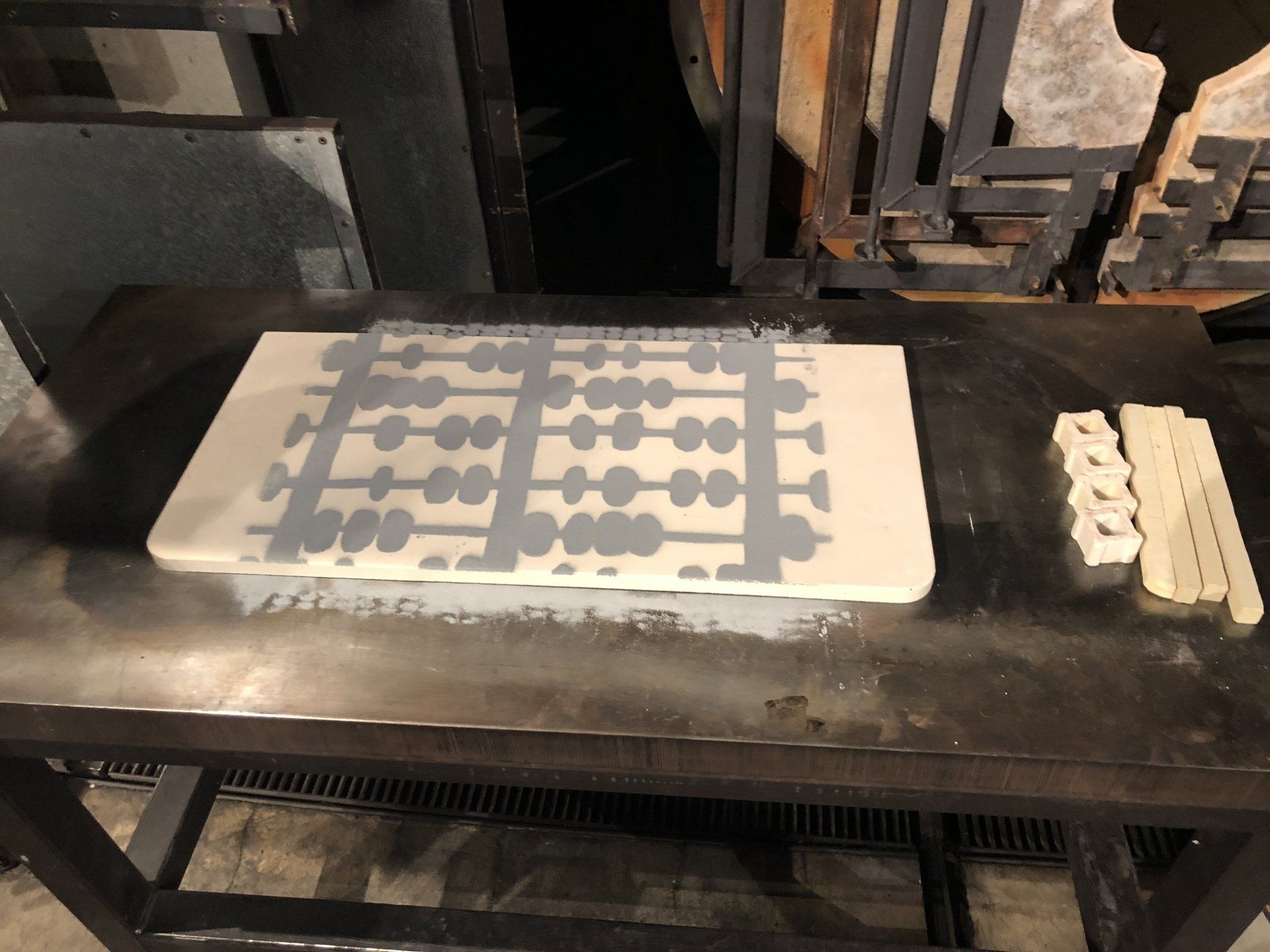 A cutting board with a pattern on it sits on a table