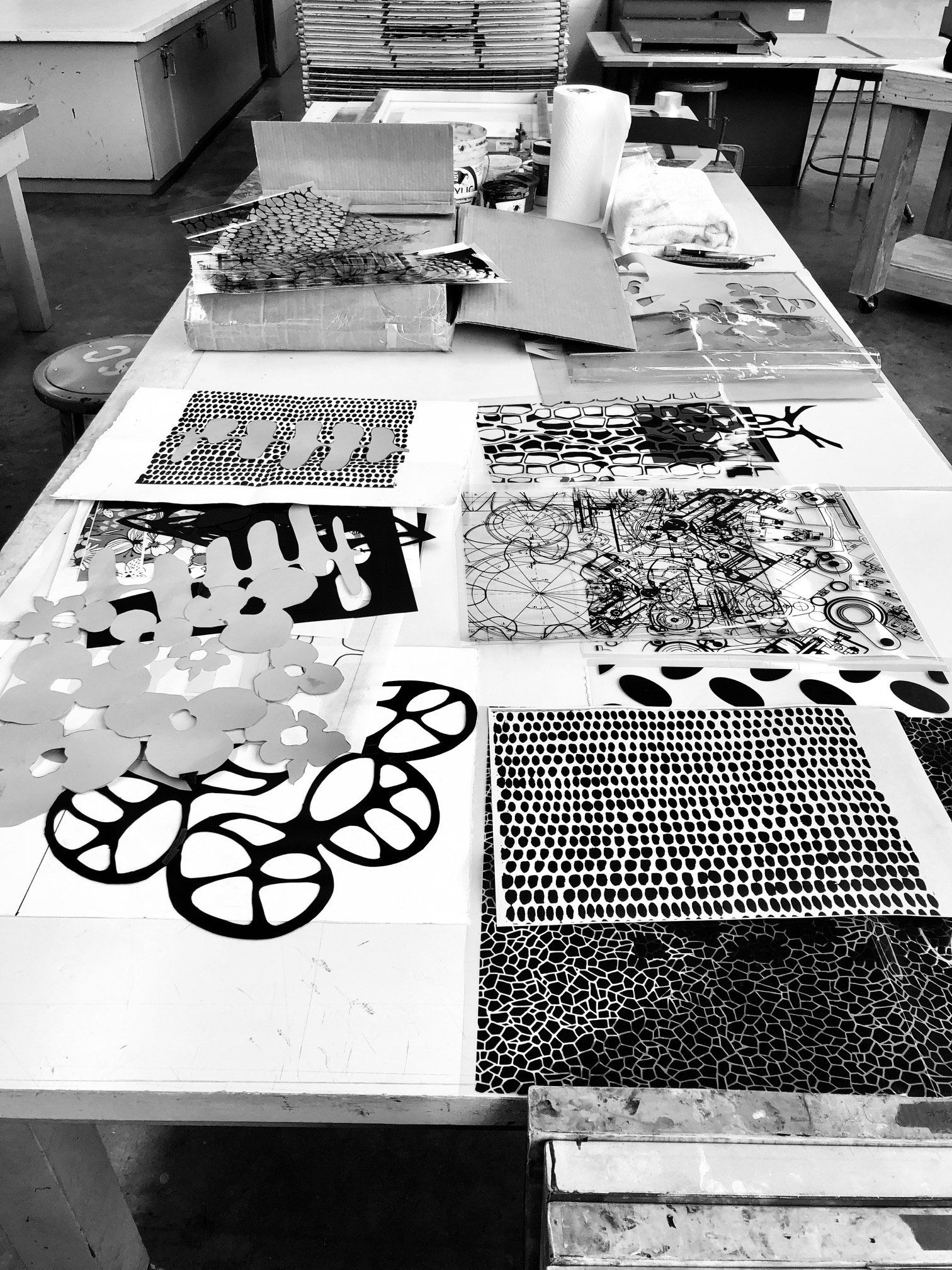 A black and white photo of a table with a few pieces of paper on it including one that says eve