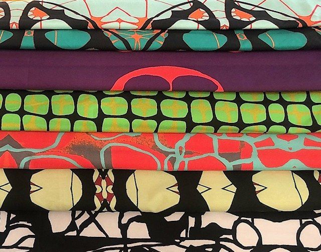 A stack of colorful fabrics with geometric designs on them