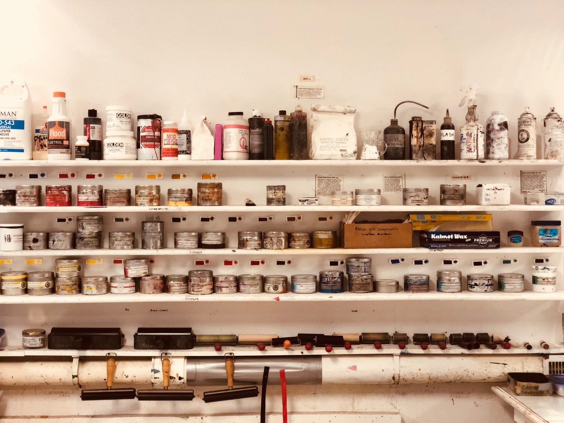 A shelf full of bottles and jars including one that says ' a ' on it