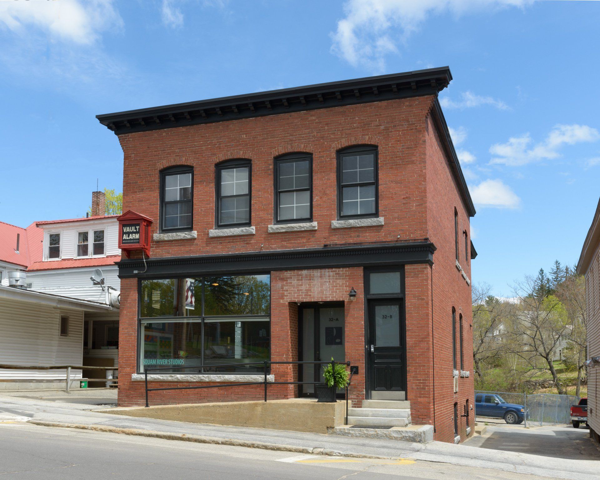 A brick building with a red sign that says ' a & a ' on it