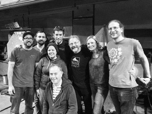 A group of people are posing for a picture together in a black and white photo.