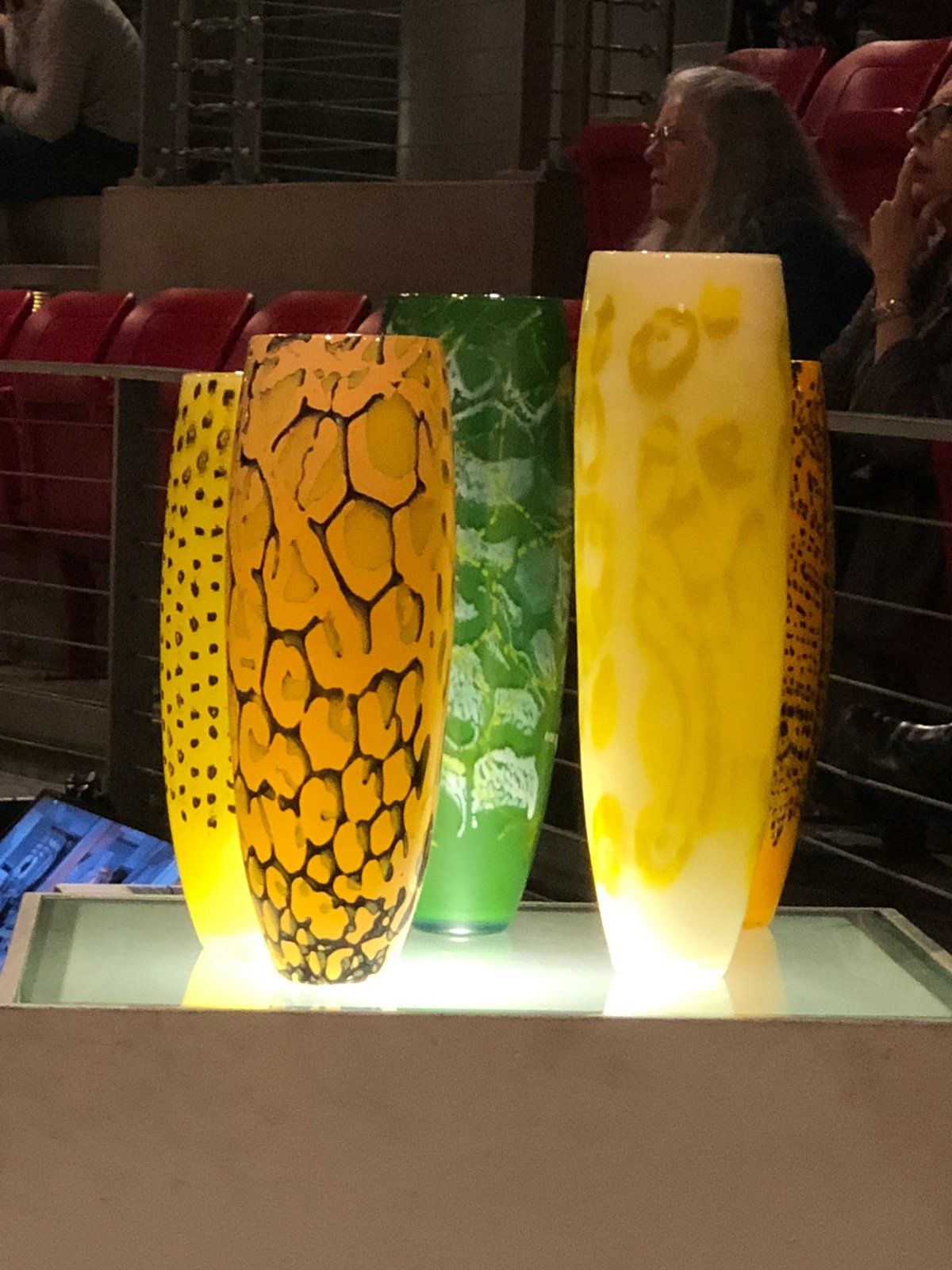 Three vases with different designs are on a table