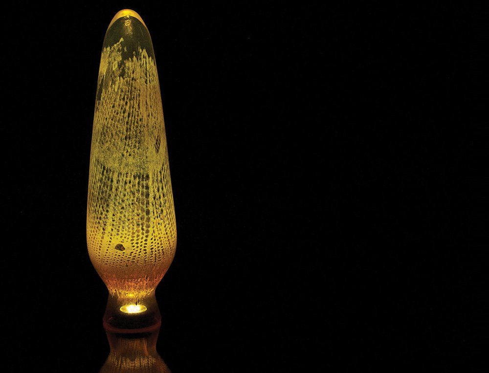 A lava lamp is lit up in the dark