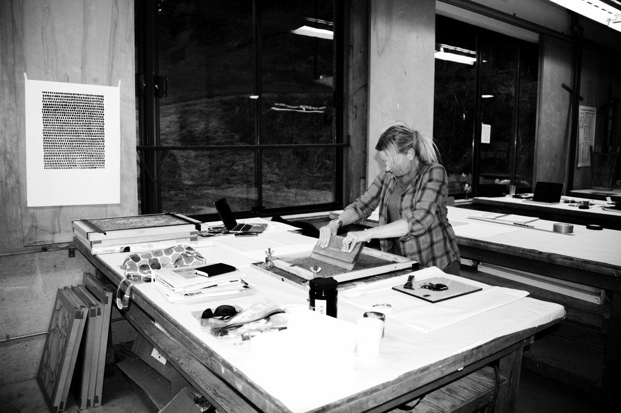 A black and white photo of a man working at a table