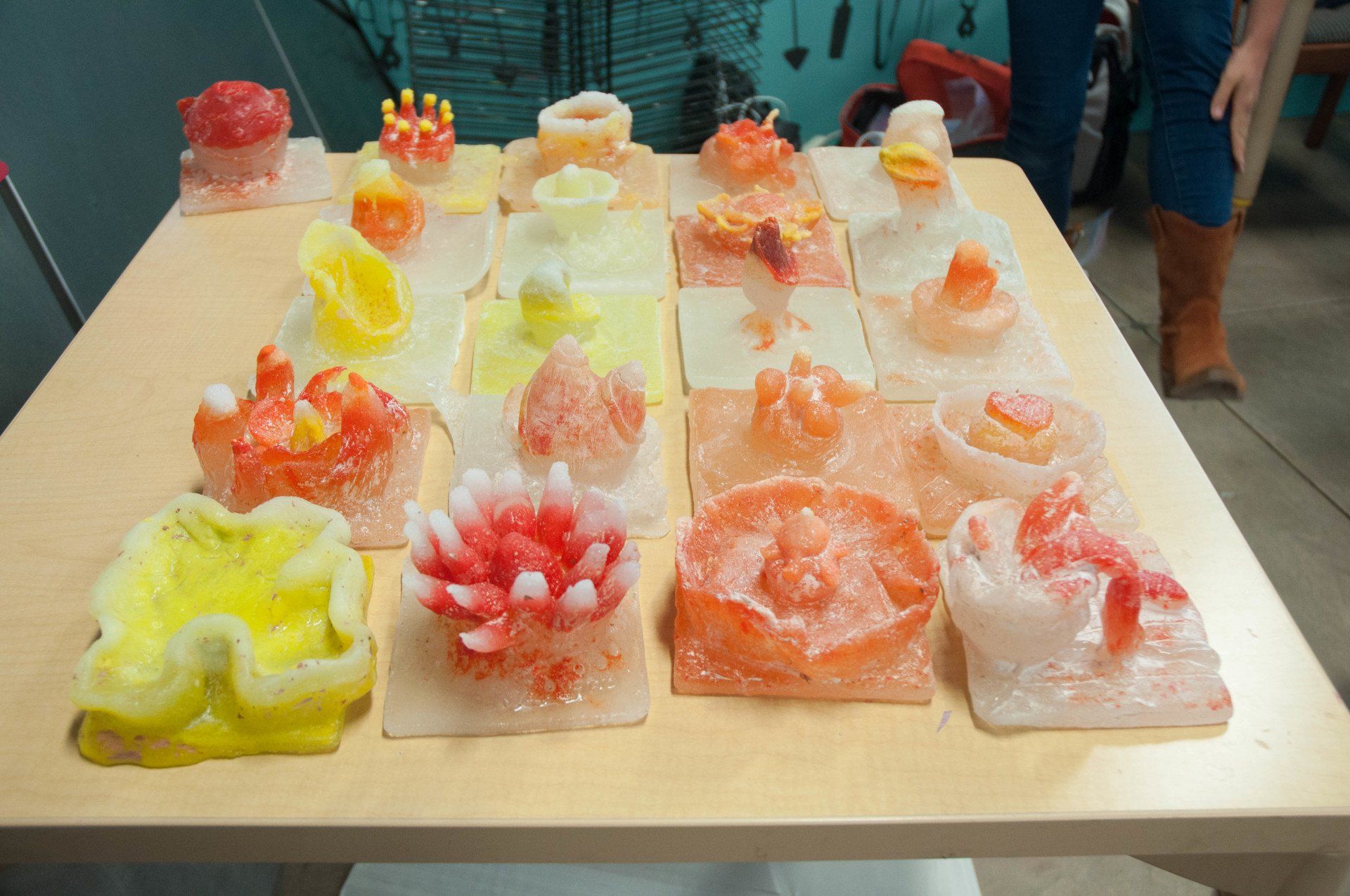 A table with many different colored candles on it