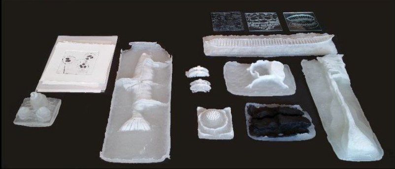 A black background with a bunch of plastic pieces on it