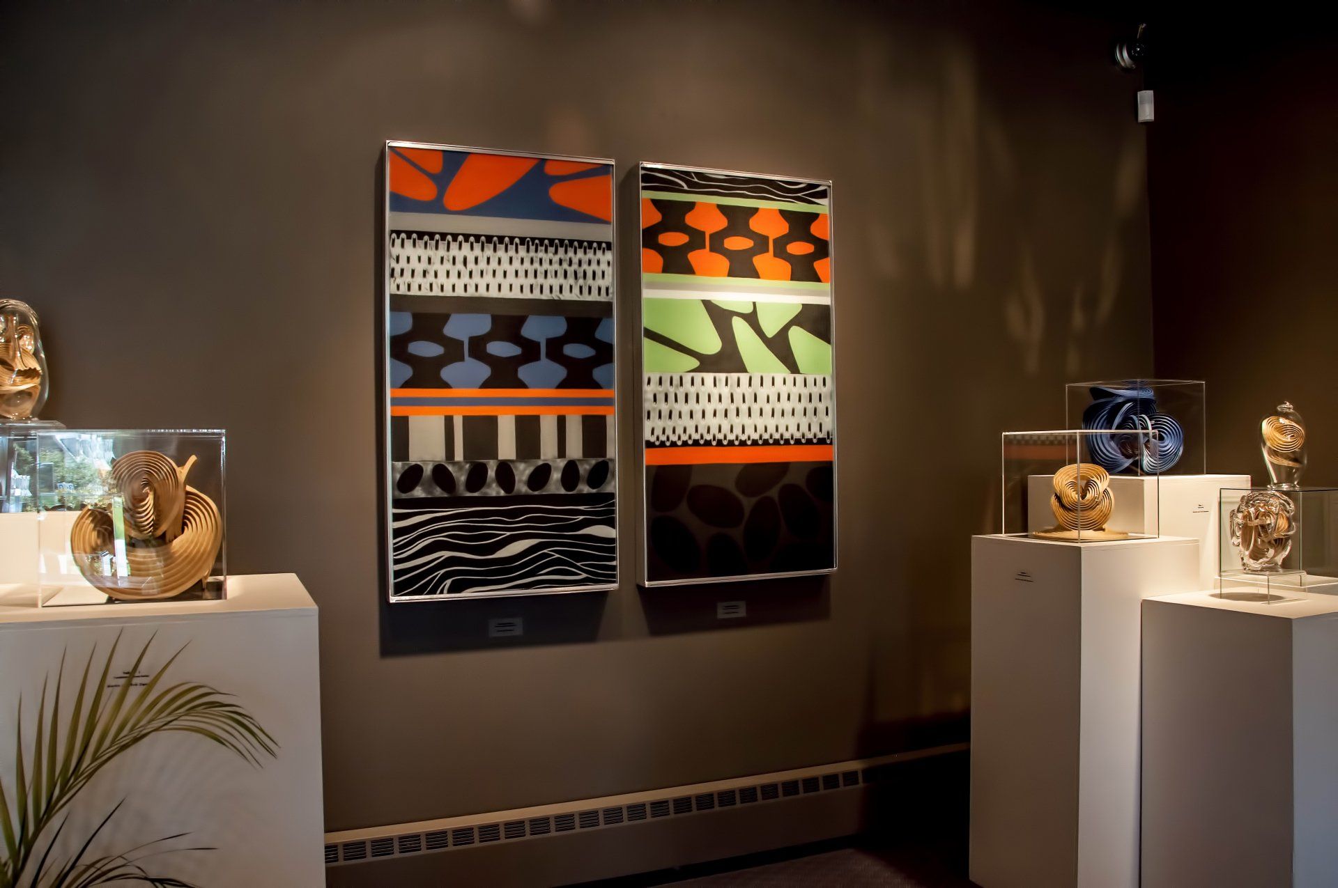 Two paintings on a wall with one that has the letter n on it