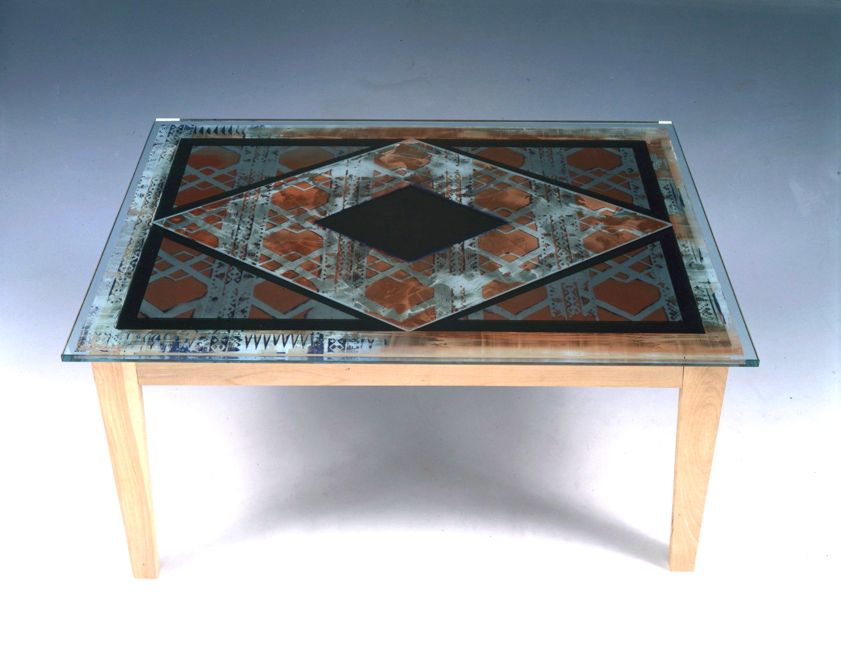 A table with a glass top and wooden legs