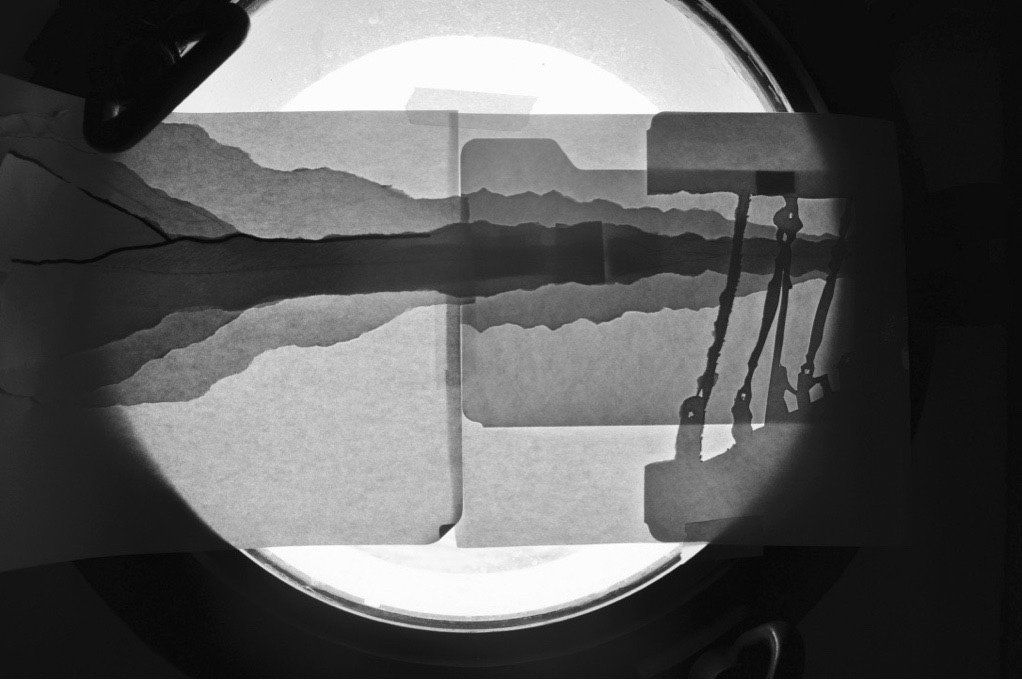 A black and white photo of a lake through a magnifying glass