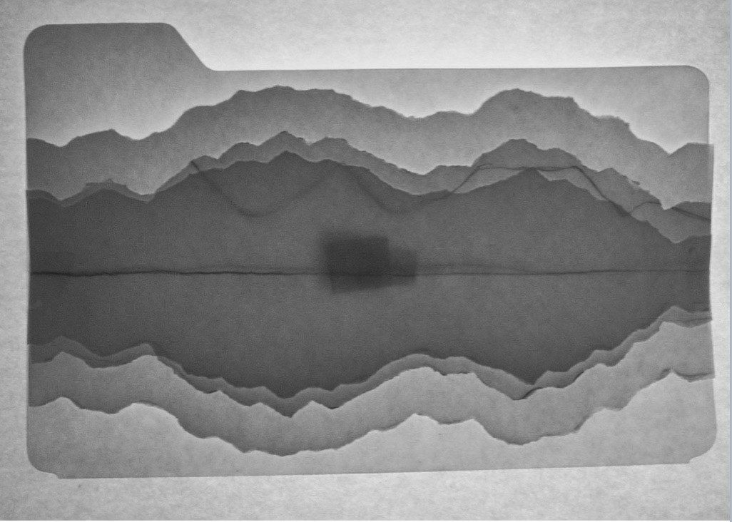 A black and white photo of mountains and a lake