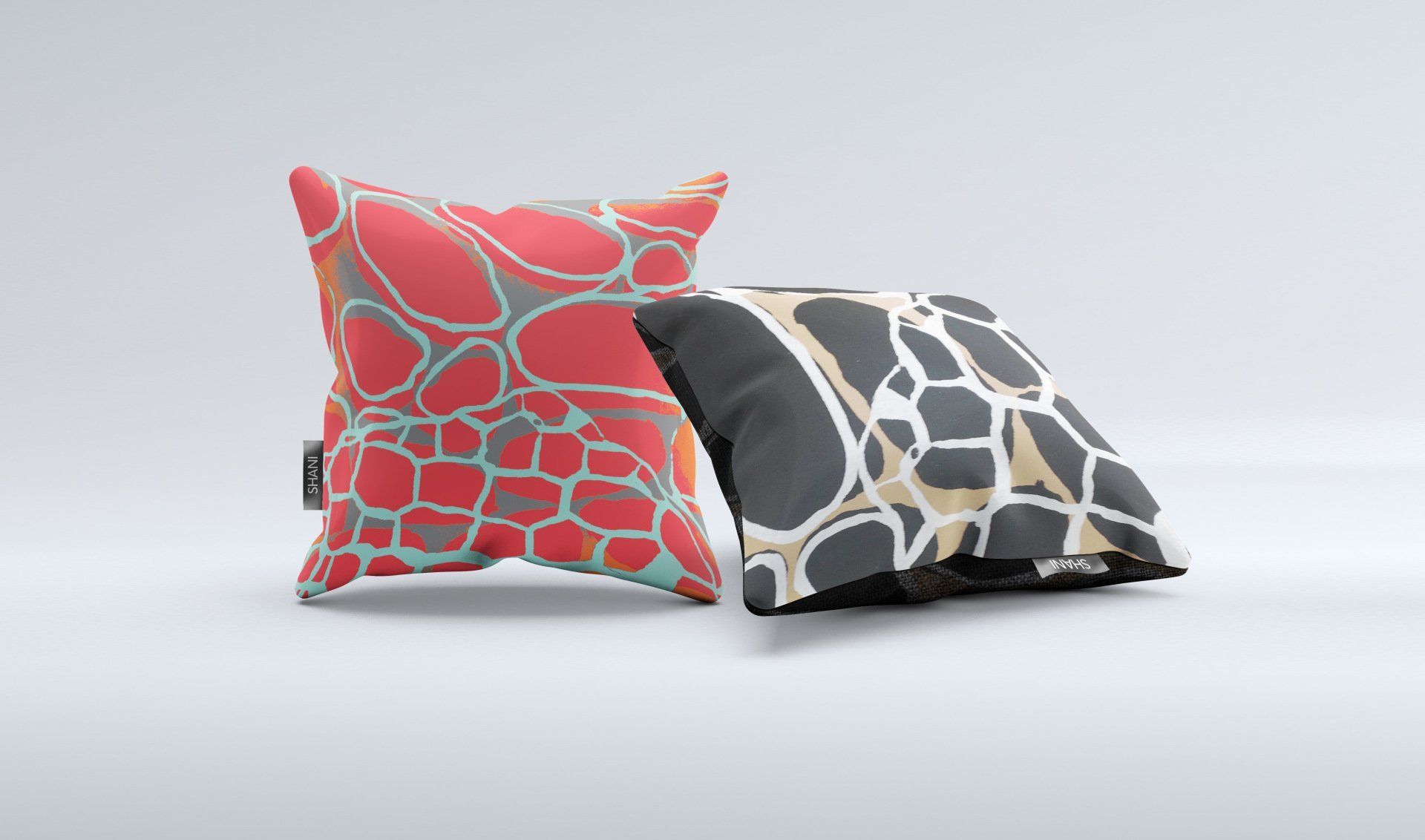 Two pillows with different designs on them are sitting next to each other