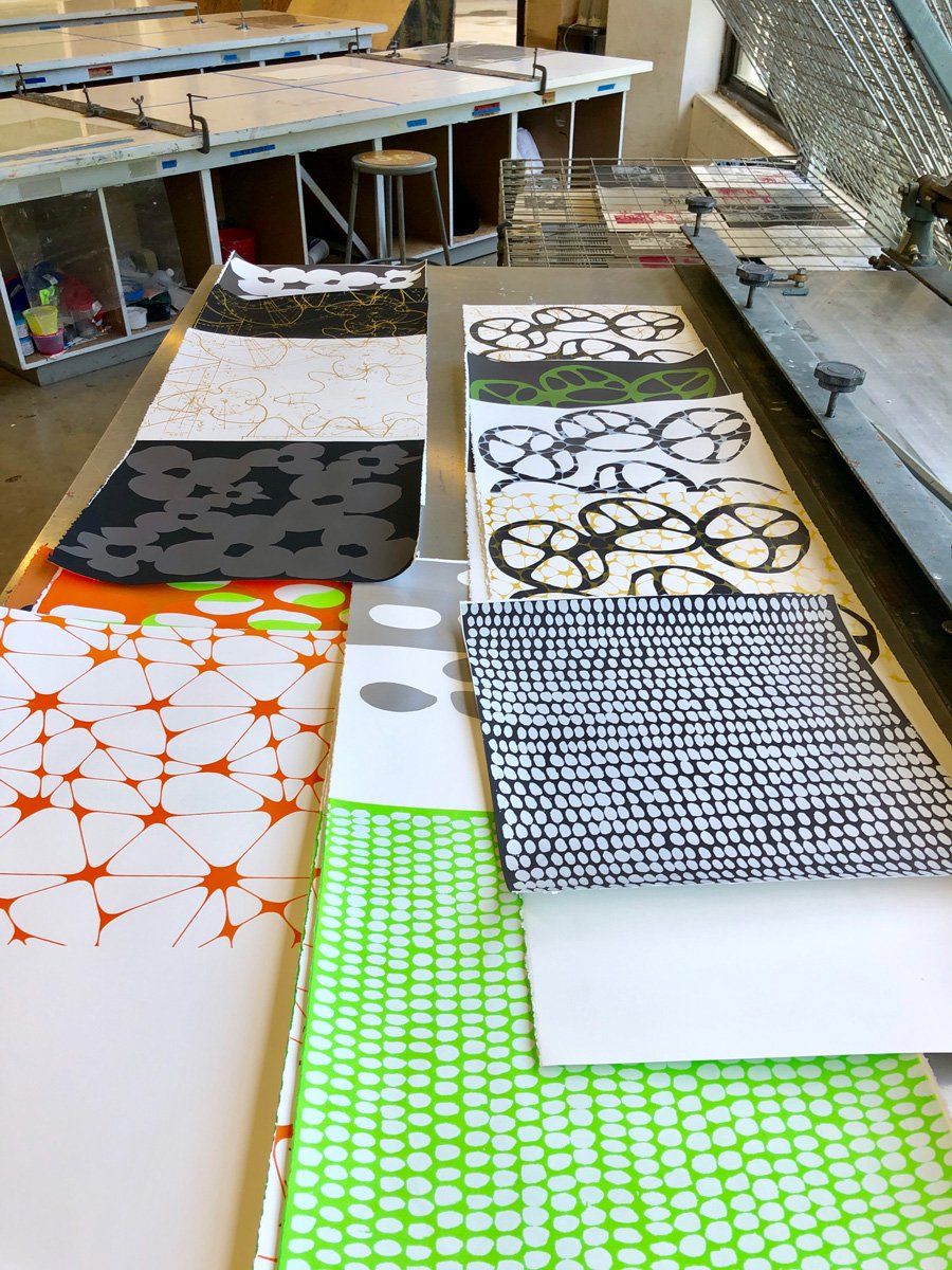 A bunch of sheets of paper with different patterns on them
