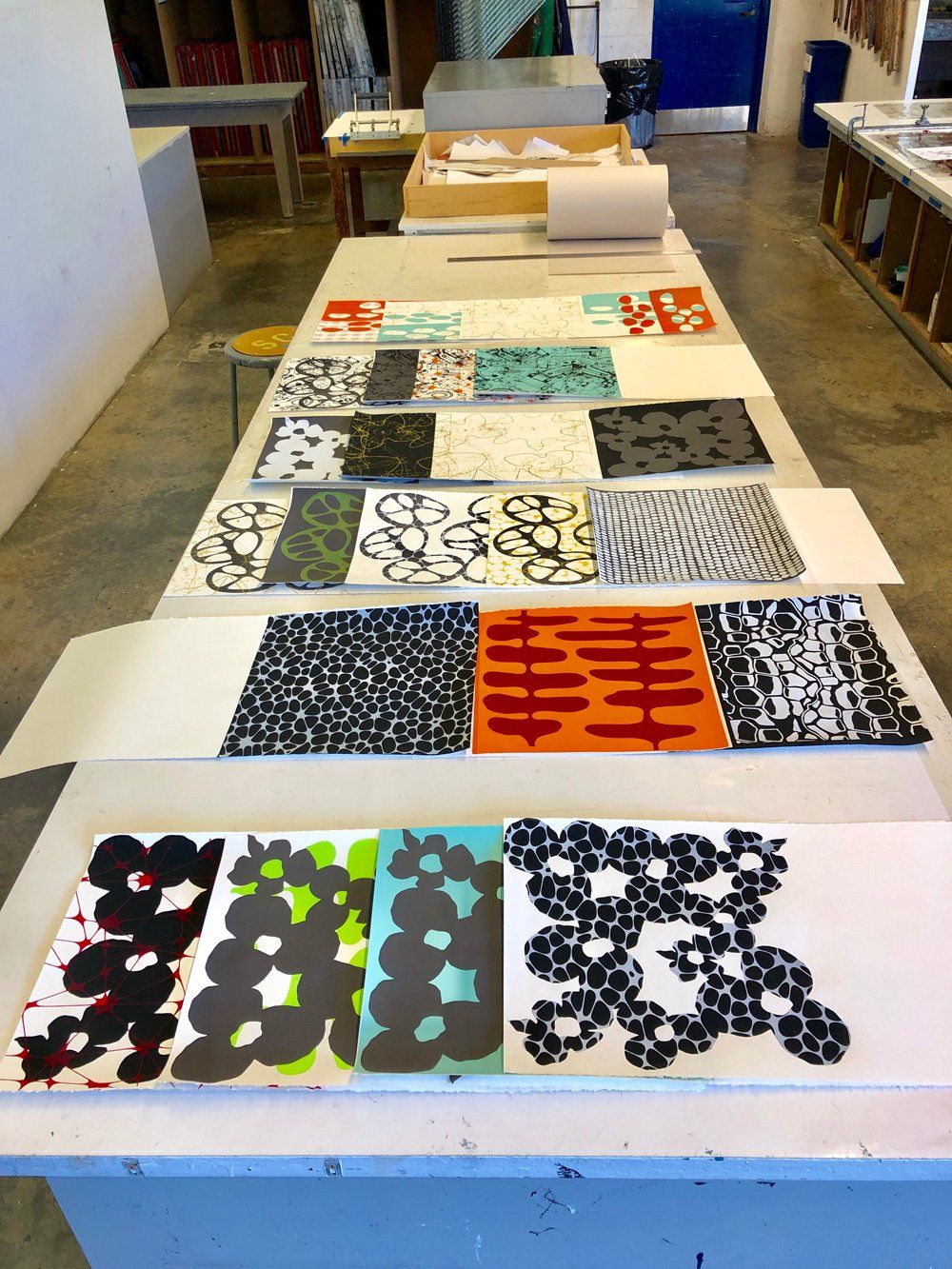 A table with a bunch of papers on it including one that says ' a ' on it