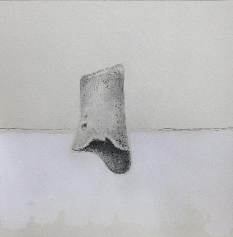 A black and white drawing of a rock on a white surface