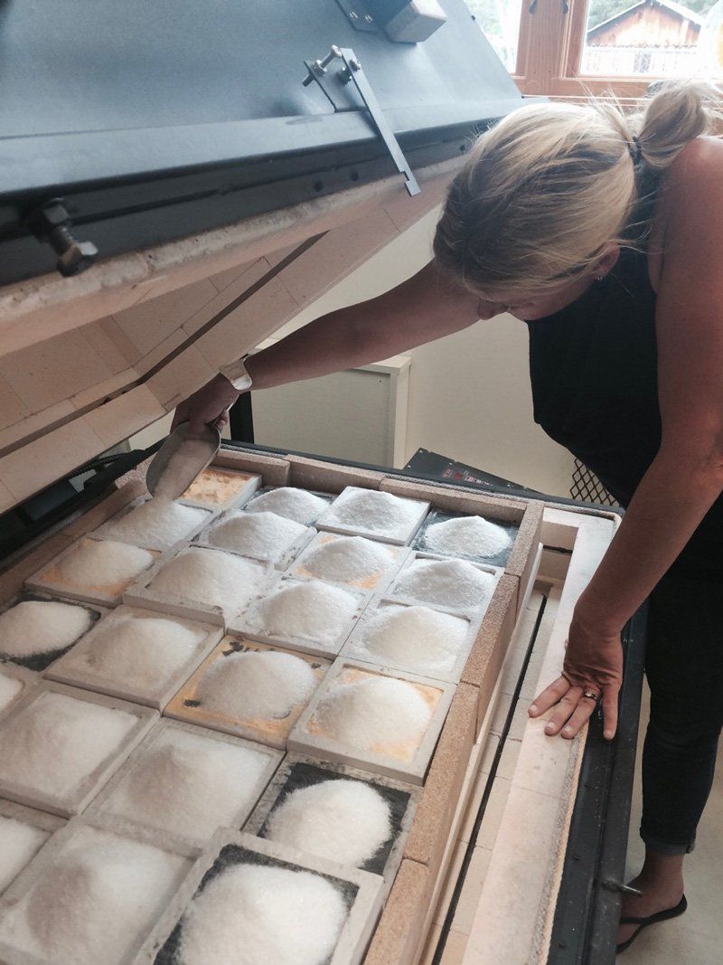 A woman is reaching into a box of salt